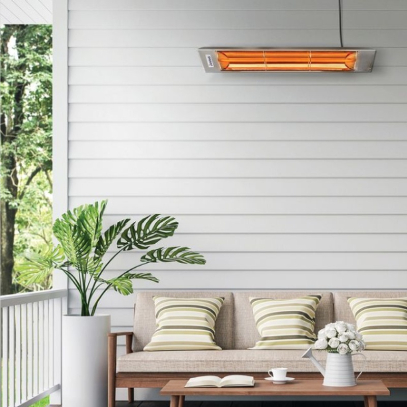 Modern outdoor living space featuring a stylish electric patio heater, comfortable beige sofa with striped cushions, and decorative plants, ideal for cozy gatherings.