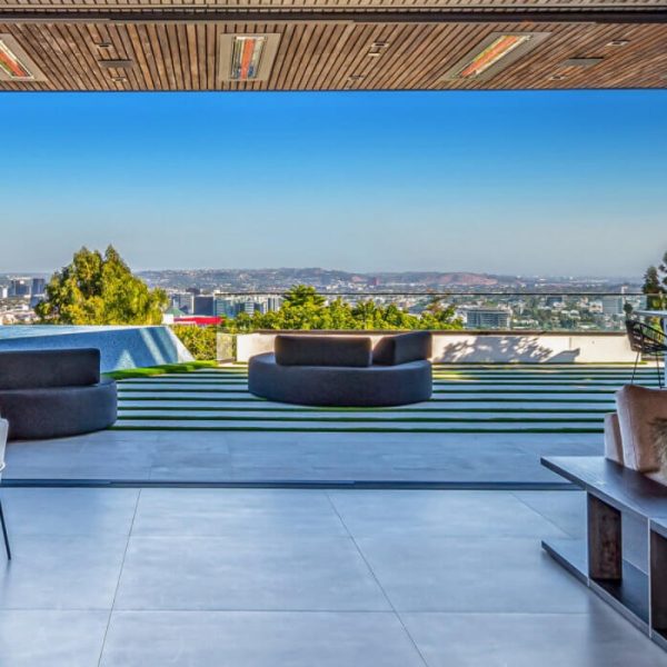 Modern outdoor living space with a panoramic city view, featuring stylish seating and a sleek design.