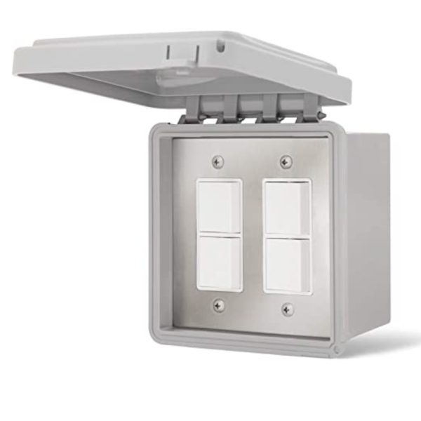 Weatherproof electrical switch box with four white switches and a hinged lid, designed for outdoor use.