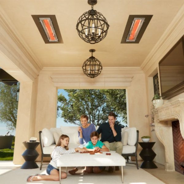 Family enjoying quality time indoors, playing a game on a coffee table, with stylish pendant lights and infrared heaters above, creating a cozy atmosphere.