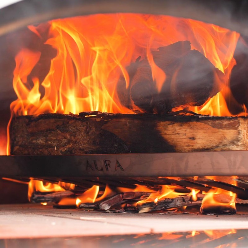 Close-up of a wood-burning oven with bright flames and burning logs, showcasing the intense heat and cooking potential.