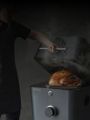 Person lifting the lid of a modern smoker with a perfectly cooked turkey inside, surrounded by steam.