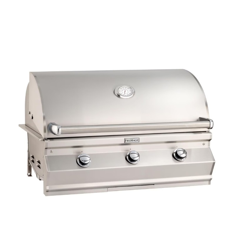 Stainless steel Fire Magic outdoor grill with three knobs and built-in temperature gauge, ideal for backyard barbecues.