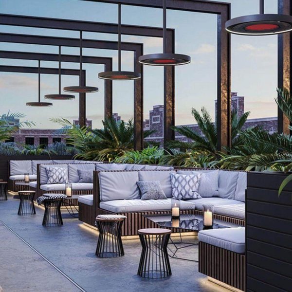 Stylish outdoor lounge area with modern seating, ambient lighting, and lush greenery, perfect for relaxation and social gatherings.