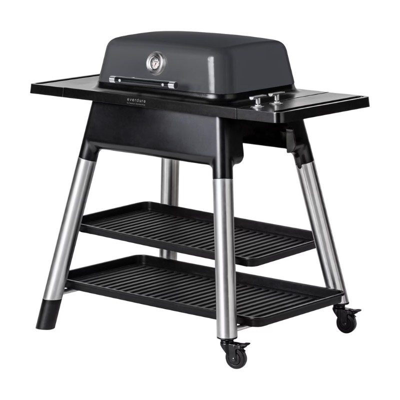 Everdure portable gas grill with a sleek gray design, featuring a cooking surface, side shelves, and two storage racks on a wheeled base for easy mobility.