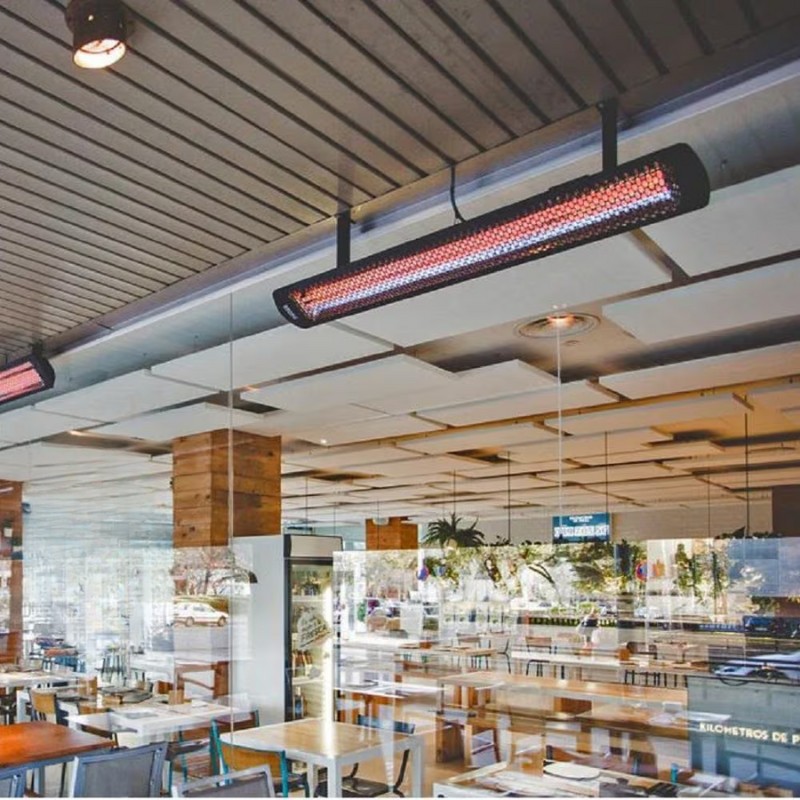 Interior view of a modern restaurant featuring overhead infrared heaters, providing warmth and ambiance in a stylish dining space with wooden accents and ample seating.