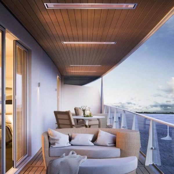 Modern balcony with stylish furniture, including a cozy sofa and dining table, offering a scenic view of the water and sky. The space features wood paneling and ambient lighting, creating an inviting outdoor atmosphere.