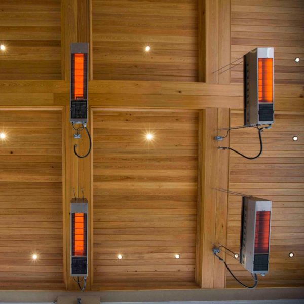 Infrared ceiling heaters mounted on a wooden ceiling, providing efficient warmth and ambient lighting in a modern interior space.