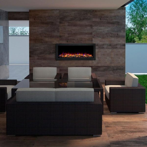 Modern outdoor living space featuring a stylish seating arrangement with gray cushions, a glass-topped table, and an electric fireplace mounted on a textured wood wall.