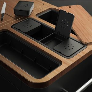 Modern kitchen countertop featuring bamboo accents and black storage containers for organized food preparation. A knife is placed nearby, highlighting functionality and style.