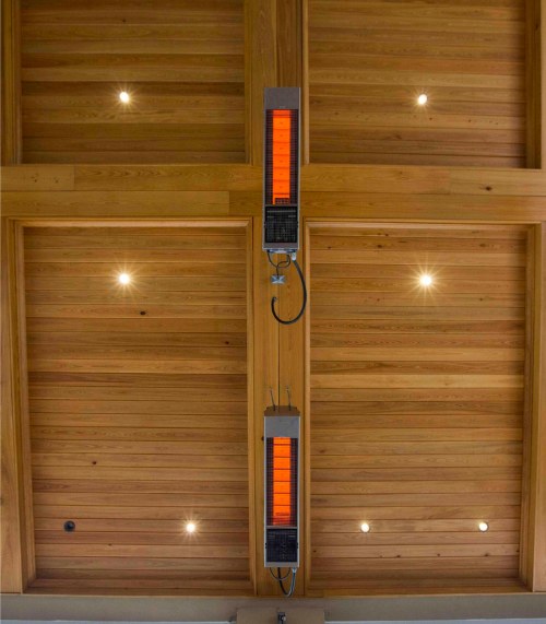 Infrared ceiling heaters mounted on a wooden ceiling, providing efficient warmth and ambient lighting.