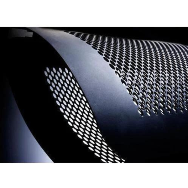 Close-up of a curved metal panel with a perforated design, showcasing a modern industrial aesthetic against a dark background.