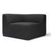 Modern black upholstered corner chair with a minimalist design, featuring rounded edges and a spacious seat.