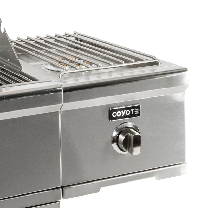 Coyote stainless steel grill with adjustable control knob and grilling surface. Ideal for outdoor cooking and barbecues.