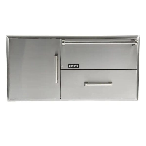 Stainless steel outdoor kitchen storage cabinet with two doors and a drawer, featuring Coyote branding. Ideal for organizing grilling tools and accessories.