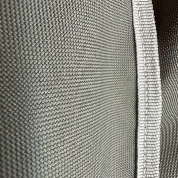 Close-up of textured gray fabric with a white edge, showcasing the weave pattern and material quality.