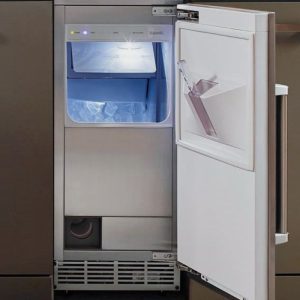 Interior view of a modern refrigerator with an ice maker, featuring a lit compartment filled with ice cubes and a sleek design.
