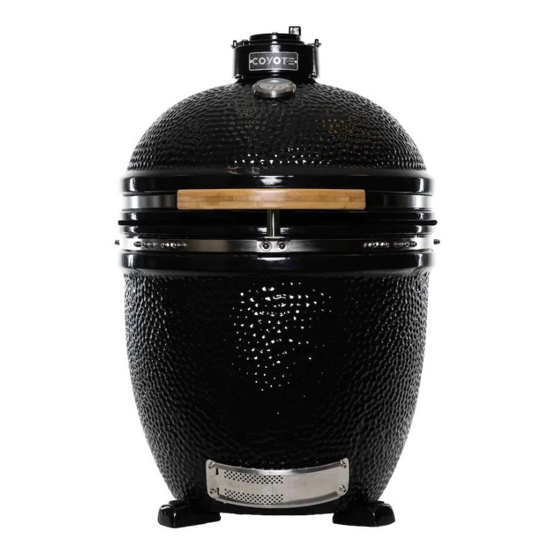 Coyote ceramic kamado grill with a glossy black finish and wooden handle, designed for versatile outdoor cooking.
