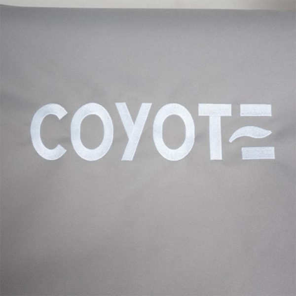 Embroidered "COYOTE" logo on a gray fabric background, showcasing modern design and branding.