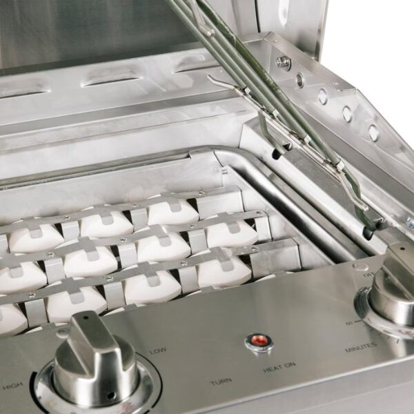 Close-up of a stainless steel gas grill interior, featuring multiple burners and control knobs for temperature settings.