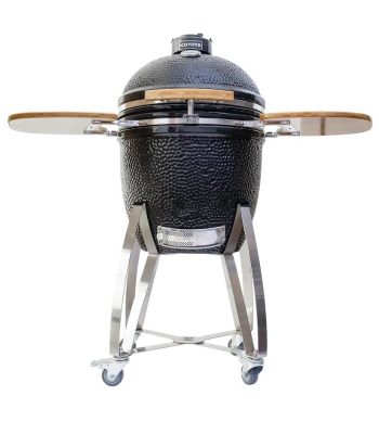 Coyote ceramic kamado grill with stainless steel cart and bamboo side shelves, ideal for outdoor cooking and grilling.