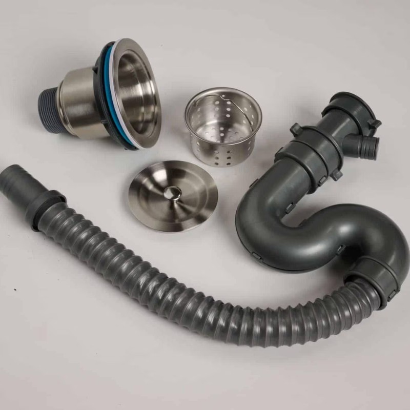 Stainless steel sink drain assembly components including a drain strainer, flexible hose, and curved pipe, arranged on a neutral background.