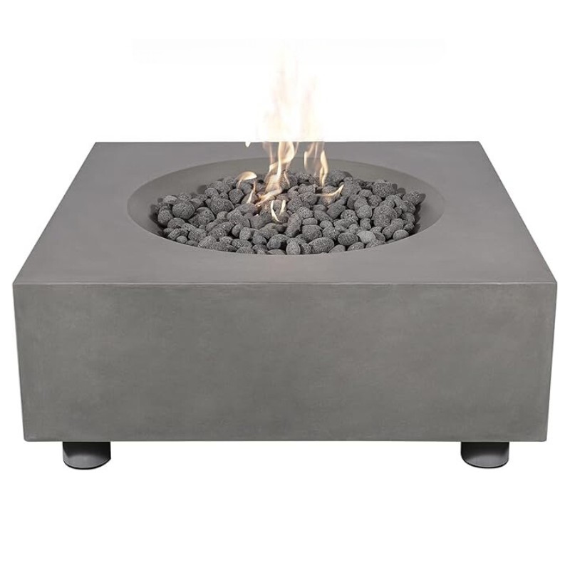 Modern square concrete fire pit with black lava rocks and flames, perfect for outdoor gatherings and ambiance.