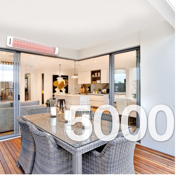 Modern outdoor dining area with wicker furniture and a view of a contemporary kitchen, featuring large glass doors and stylish decor.