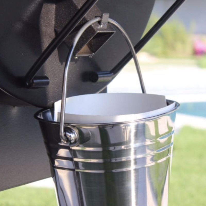 Stainless steel bucket attached to a grill, designed for easy waste collection and disposal.
