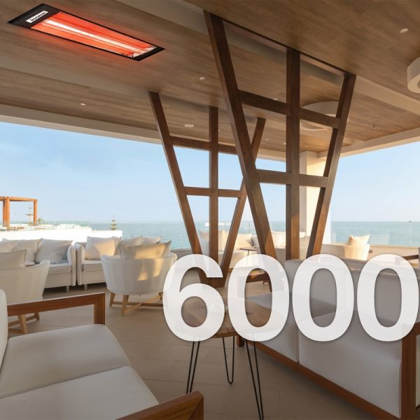 Modern outdoor seating area with a stylish wooden structure and infrared heater, overlooking the ocean.