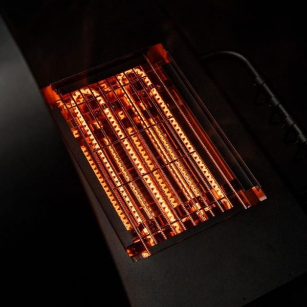 Infrared heater with glowing heating elements providing warmth in a dark setting.