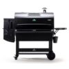 GMG Peak pellet grill with digital controls, side shelf, and storage bucket, designed for efficient outdoor cooking.