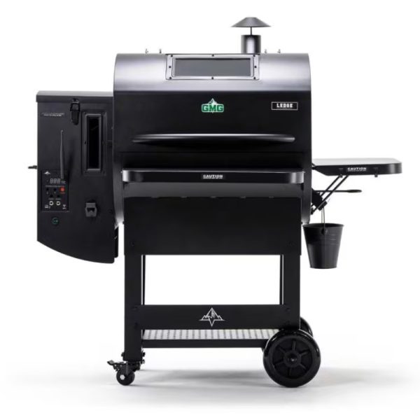 Black GMG Ledge pellet grill with digital control panel, side shelf, and storage bucket, designed for outdoor cooking.