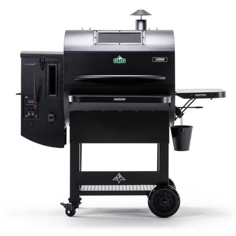 Black GMG Ledge pellet grill with digital control panel, side shelf, and storage bucket, designed for outdoor cooking.