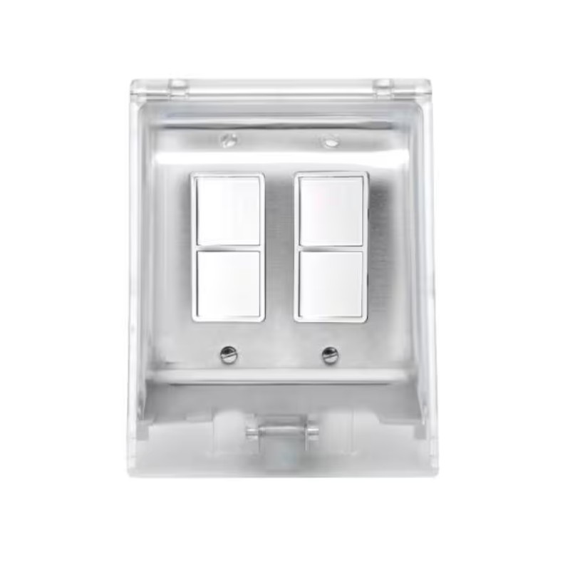 Clear plastic electrical switch cover with two metallic switches. Ideal for modern home decor and functionality.