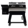 Black and stainless steel pellet grill with digital controls, side shelf, and storage cart, ideal for outdoor cooking and grilling.