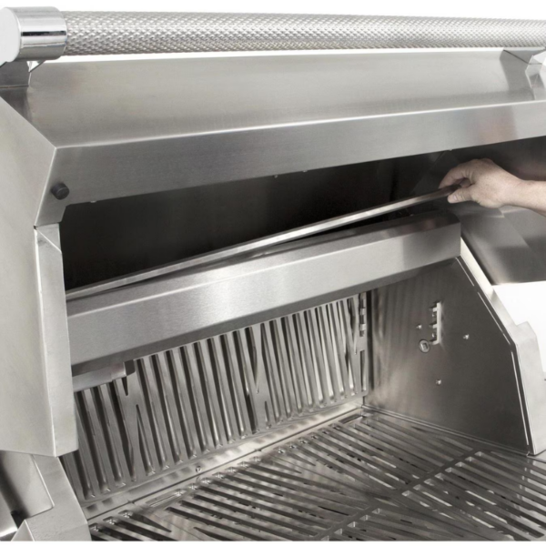 Close-up of a stainless steel grill with a hand adjusting the grease tray, showcasing its durable construction and functional design for outdoor cooking.