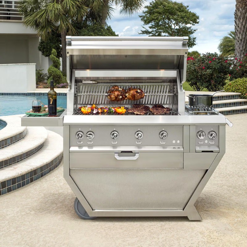 Stainless steel outdoor grill with an open lid, featuring grilled meats and vegetables, set by a swimming pool with a bottle of wine and glass nearby.