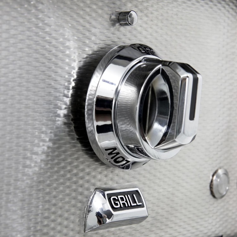 Close-up of a stainless steel grill control knob with "GRILL" label, showcasing a sleek design and modern features.