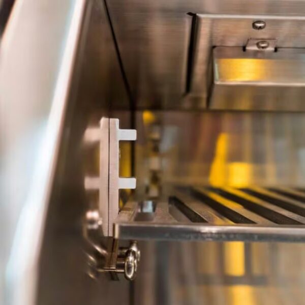Close-up of a stainless steel refrigerator interior showing a metal shelf bracket and slatted shelf, highlighting modern kitchen appliance design.