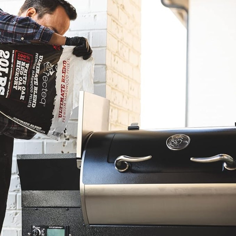 Man loading premium hardwood pellets into a pellet grill for outdoor cooking.
