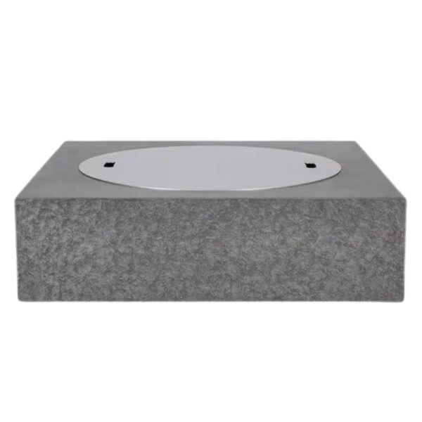 Concrete base with a circular metal cover, designed for outdoor installations or utility access.