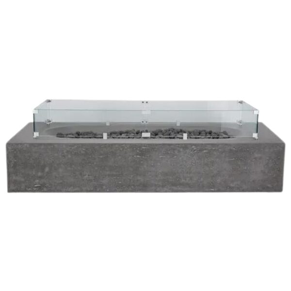 Modern concrete fire pit table with glass wind guard and decorative stones. Ideal for outdoor gatherings and enhancing patio aesthetics.