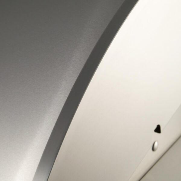 Close-up of a sleek, brushed metal surface with a curved edge, highlighting modern design and craftsmanship.