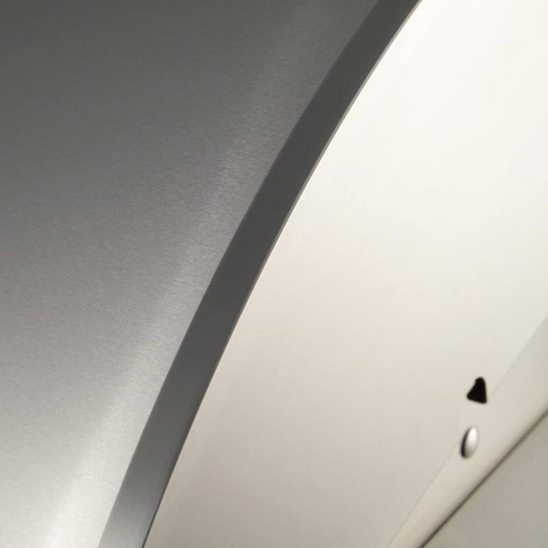 Close-up of a sleek, brushed metal surface with a curved edge, highlighting modern design and craftsmanship.
