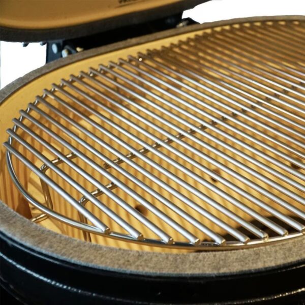 Close-up of a stainless steel grill grate inside a ceramic barbecue, showcasing its sleek design and heat-resistant features for optimal cooking.