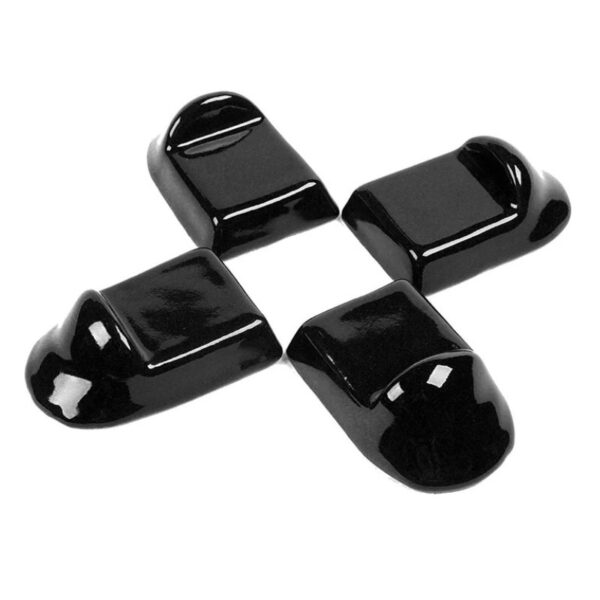 Four black plastic caps with various shapes, commonly used for furniture leg protection or covering.