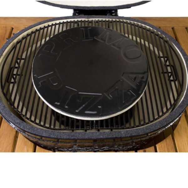 Primo pizza stone placed inside a ceramic grill, showcasing the cooking surface and grill grates. Ideal for outdoor pizza baking.