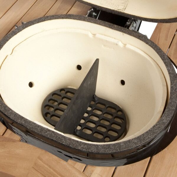 Ceramic grill interior with a black grilling grate and divider, showcasing a spacious cooking area designed for even heat distribution.