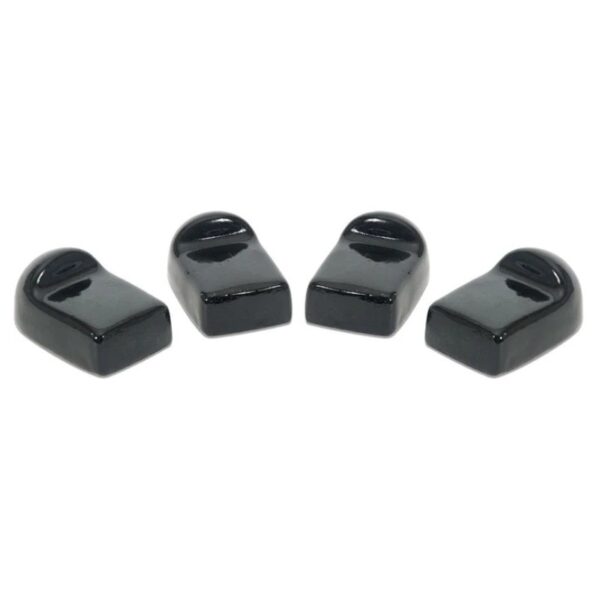 Four black ceramic shoe-shaped figurines arranged in a row, ideal for decorative purposes or as unique collectibles.